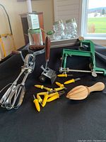 Overview of vintage kitchen collection featuring hand mixer, pasta roller, corn holders, citrus reamer, nut chopper and bear-shaped honey jars.
