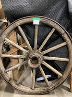 Full front view of wooden wagon wheel showing 12 spokes and metal hub