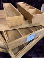 Stacked view of the 4 large expandable bamboo drawer dividers showing wood grain and expandable slots.
