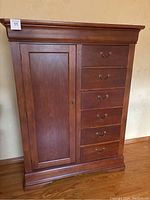 Front view of chest showing cabinet door, five drawers, and overall profile