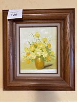 Full view of framed oil painting showing yellow roses in vase by Robert Cox, wood frame.