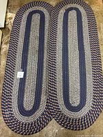 Pair of oval braided chenille runners side by side showing overall pattern and condition.