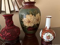 Grouped photo of all three vases showing different styles and sizes on a wooden surface.