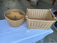Two large woven wicker baskets on a table, one round with a 4-slot divider inside, and one rectangular with handles.