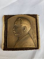 Square bronze medal with relief portrait of Edward Dean Adams, with inscriptions "Edward Dean Adams geb 1846" and German text on side.
