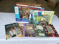 First photo showing a box of quilting books with some displayed in front, titles visible include Weekend Scrap Quilting, Still Stripping After 25 Years, Quilt Favorites, and Fast Fun & Fabulous Quilts.