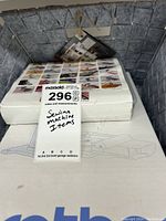 Boxed sewing machine items labeled 'Sewing machine items' with lot tag visible