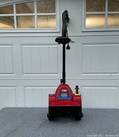 Front view showing red housing, TORO Power Shovel Plus label and auger intake.