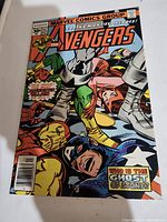 Front cover of Avengers issue 157 comic from 1977. Shows vibrant colored illustration of multiple characters including Captain America, Iron Man, Thor, and others trapped in stone or chains. Comic title and issue number visible on top.