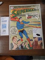Front cover of Superman comic no 125, showing Superman with rainbow-colored power beams flying. Visible wear and tear on the cover edges.
