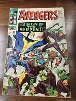 Front cover of The Avengers comic book #32 showing action-packed superhero scene with The Sign of the Serpent title. 12 cent price visible.