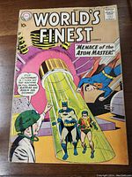 Front cover of World's Finest Comics No.101 showing Batman and Robin trapped in a yellow containment tube with Superman and a scientist present, priced at 10 cents, dated May 1959.