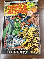 Front cover of the vintage Marvel Triple Action No. 2 comic book showing key characters including Doctor Doom, Silver Surfer, and The Thing with colorful action art.