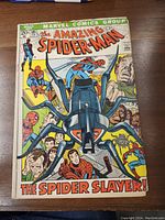 Front cover of The Amazing Spider-Man No. 105 comic book showing Spider-Man facing the Spider Slayer robot with multiple Spider-Man images around.