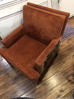 Armchair front and top view showing burnt orange upholstery and shape