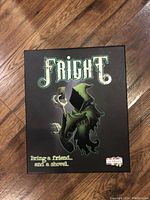 Front of the Fright board game box showing the title and artwork of a cloaked figure holding a lantern.