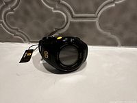 Black Soleus GPS watch with yellow button and logo, face visible, new with tag attached.