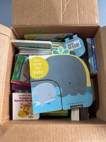 Top view of box showing various baby books including 'You Are My Baby'