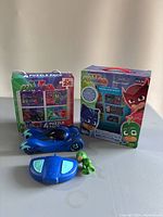 Photo showing four-pack puzzle pack, blue remote control car, green action figure, and blue remote control.