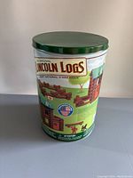 Metal storage bin featuring the original Lincoln Logs branding and colorful graphics.