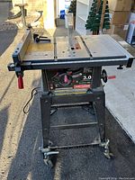 Front and side view of Craftsman table saw on stand, showing control panel and blade guard.