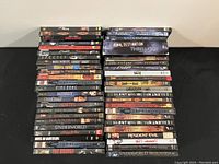 Photo showing stacked DVD cases of horror movies with visible titles and spines.