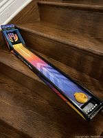 Front view of tabletop skeetball arcade game showing digital scoreboard and colorful playing surface with skeetball launcher