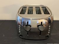 Front view of the 4-slice stainless steel toaster showing dual lever controls and buttons