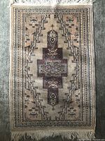 Top view showing full rug with geometric center medallion and intricate border.