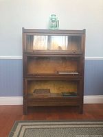 Front view of assembled bookcase with stand and top