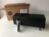 Black rectangular metal unit with removable handle in plastic bag and original cardboard box.