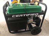 Front-side angle showing green tank, black frame, wheels