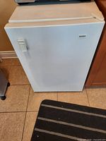 Front view of white Kenmore standing freezer