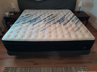 Front view of assembled king mattress, box spring and metal frame
