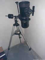 Front and side view of telescope on tripod showing optical tube, mount, tripod