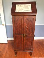 Front view of cabinet with flip-top closed and decorative map insert (map not included)
