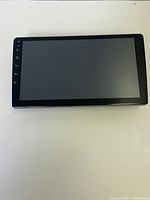 Front view of the dash cam device showing the screen and side buttons