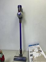 Assembled vacuum upright next to its original box