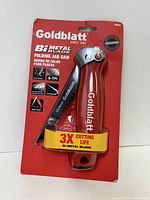 Front view of Goldblatt folding jab saw in packaging showing red handle and blade, highlighting 3X cutting life and bi-metal blade features.
