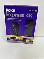 Front of the Roku Express 4K box showing the product name, an image of the device and remote, and key features such as HD, 4K, and HDR support.