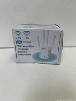 Front of the box showing product image with four antennas and AC1200 dual band WiFi coverage info.