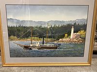 Close-up of the watercolour painting showing the steamship sailing near a lighthouse with forested background, framed under glass.