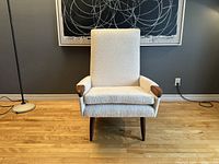 Front view of entire chair showing high back and upholstery