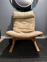 Front view of mid century modern Siesta lounge chair with light tan leather cushions and natural finish bentwood frame