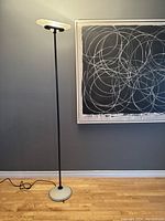 Full height view of lamp against wall showing overall design and proportions