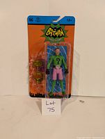 Front view of the Batman Classic TV Series Riddler action figure in original sealed blister packaging with accessories visible.