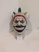 Front view of american horror story clown mask showing detailed makeup and hair tufts.