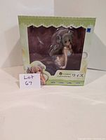 Front view of the boxed Rize anime statue showing the figure through a transparent window in the packaging.