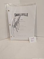 Front cover of Smallville script titled 'Kara' signed by Laura Vandervoort, secured with brass fasteners inside a plastic sleeve.