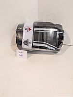Front angle of black hockey glove beer holder with white and silver stripes and Stanley Cup Playoffs logo on the white band wrapped around the glove.